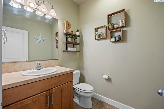 168715 W Johnson Rd, Prosser, WA 99350 - bathroom with vanity, toilet, tile patterned flooring, and baseboards