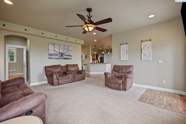 168715 W Johnson Rd, Prosser, WA 99350 - living area featuring carpet flooring, ceiling fan, arched walkways, a baseboard heating unit, and recessed lighting