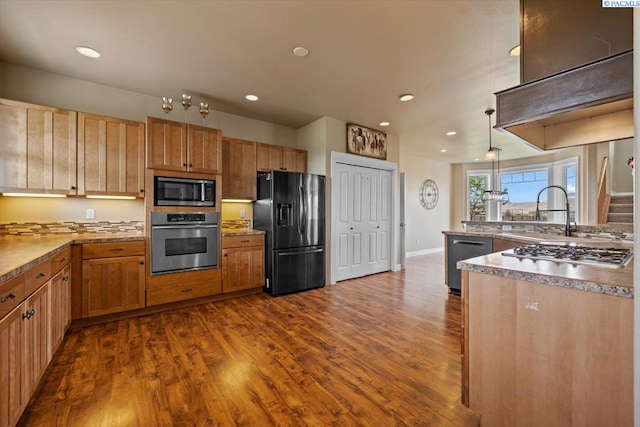 168715 W Johnson Rd, Prosser, WA 99350 - kitchen featuring appliances with stainless steel finishes, dark wood-type flooring, a sink, recessed lighting, and baseboards