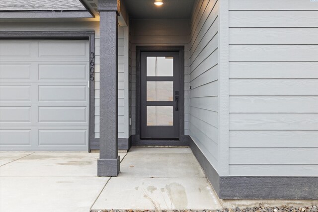 doorway to property with a garage