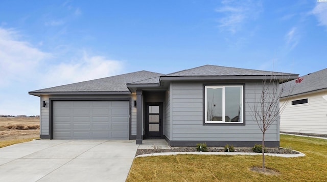 view of front of home with a garage and a front lawn