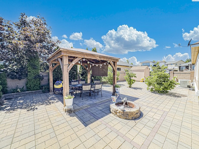 4807 Adobe Dr, Pasco, WA 99301 - fenced backyard with a gazebo, a fire pit, outdoor dining area, a patio area, and central air condition unit