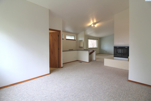 unfurnished living room featuring baseboards and carpet floors