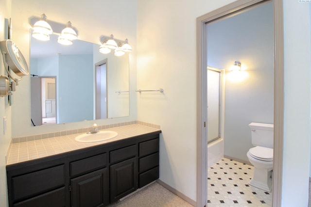 full bath with toilet, enclosed tub / shower combo, vanity, and baseboards