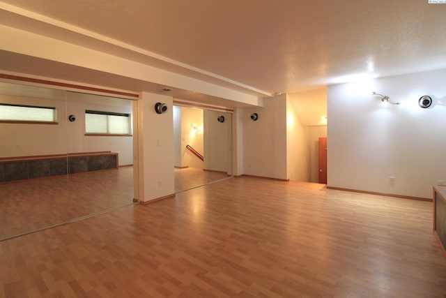 empty room with light wood-style flooring and baseboards