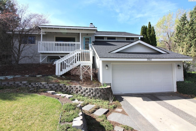 view of front facade featuring a garage, stairs, a chimney, a shingled roof, and driveway