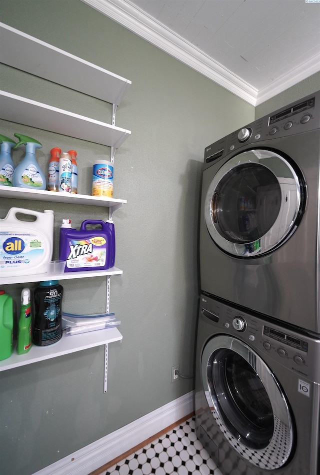washroom featuring laundry area, ornamental molding, baseboards, and stacked washing maching and dryer