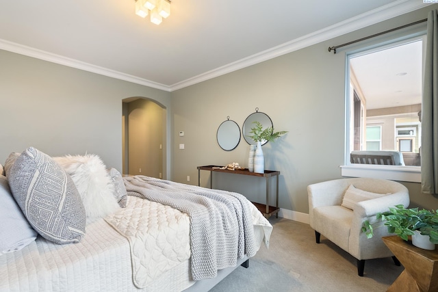 bedroom with ornamental molding and carpet flooring