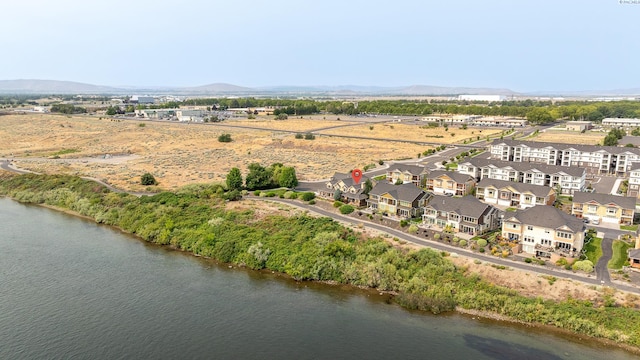 drone / aerial view featuring a water and mountain view