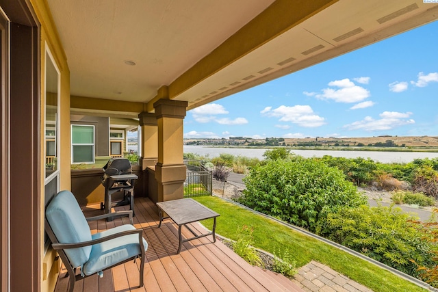 wooden deck featuring a water view