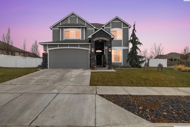 view of front of home featuring a garage and a yard