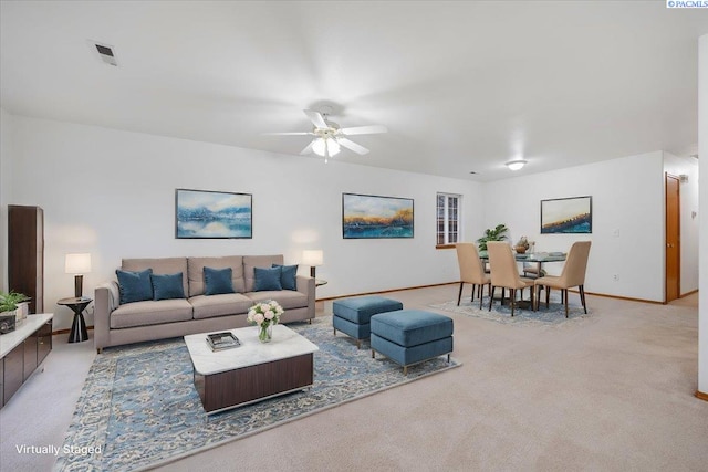 living room featuring ceiling fan and light carpet