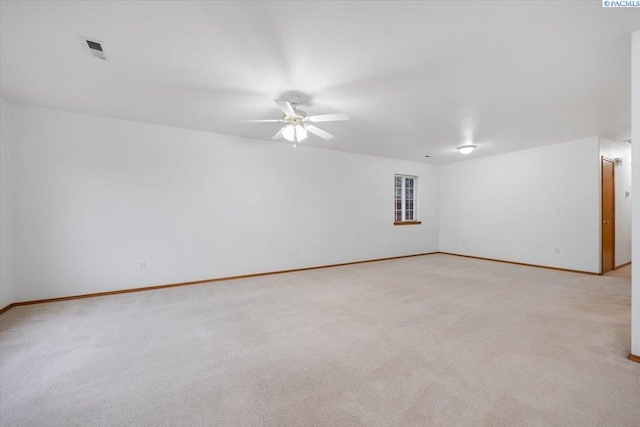 carpeted spare room with ceiling fan