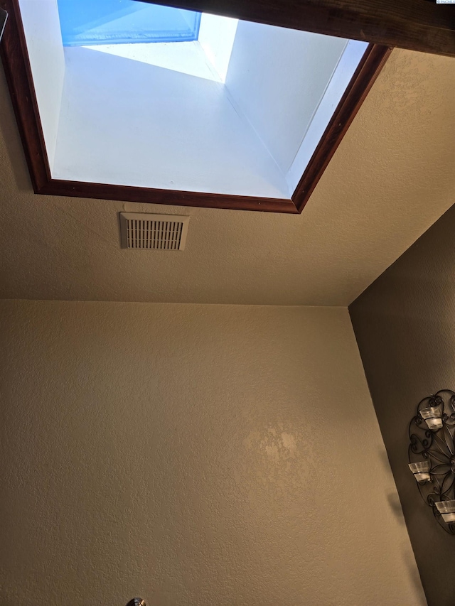 interior details featuring a skylight and visible vents