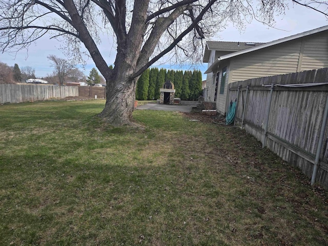 view of yard featuring a patio area and a fenced backyard