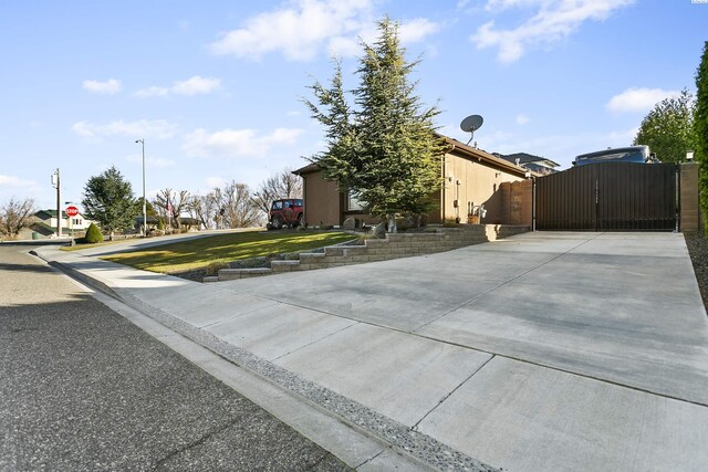 exterior space featuring a gate and concrete driveway