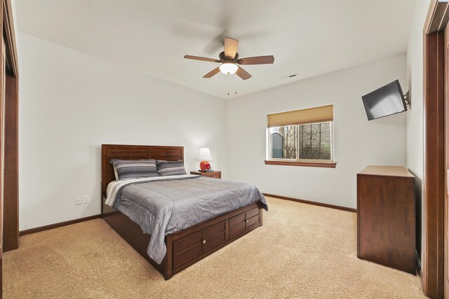 carpeted bedroom featuring a ceiling fan, baseboards, and visible vents