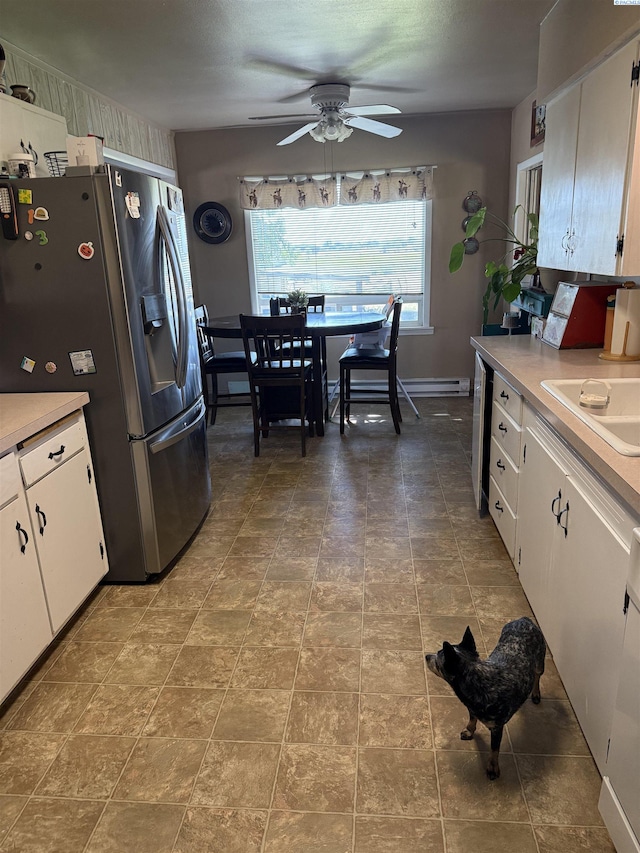 15440 W Johnson Rd, Prosser, WA 99350 - kitchen featuring stainless steel refrigerator with ice dispenser, ceiling fan, light countertops, and white cabinetry