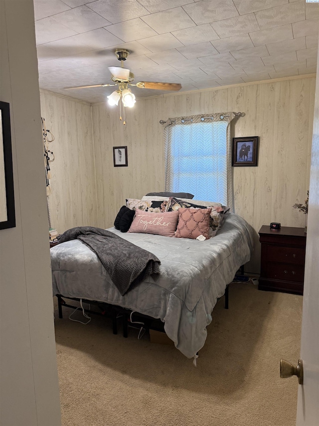 15440 W Johnson Rd, Prosser, WA 99350 - bedroom with carpet floors, wood walls, and a ceiling fan