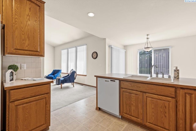 106 Muirfield Ln, Pasco, WA 99301 - kitchen with dishwasher, brown cabinets, light colored carpet, tasteful backsplash, and recessed lighting
