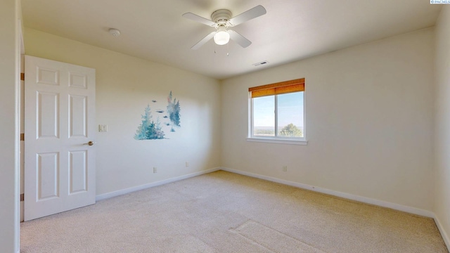 unfurnished room featuring baseboards, ceiling fan, visible vents, and light colored carpet