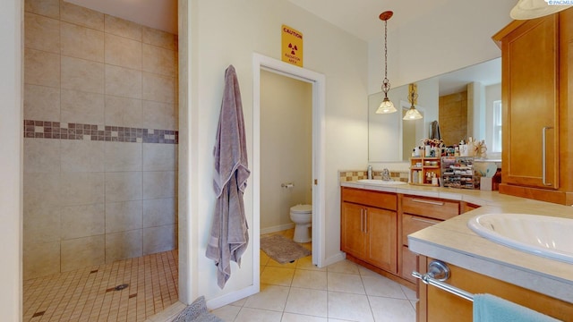full bath featuring double vanity, a sink, tile patterned flooring, and toilet