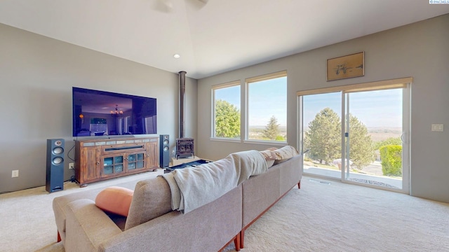 carpeted living room featuring a wood stove