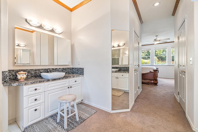 4107 Mojave Ct, Pasco, WA 99301 - bathroom featuring crown molding, vanity, decorative backsplash, a ceiling fan, and carpet floors