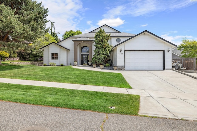 4107 Mojave Ct, Pasco, WA 99301 - view of front of property with an attached garage, a front yard, and concrete driveway