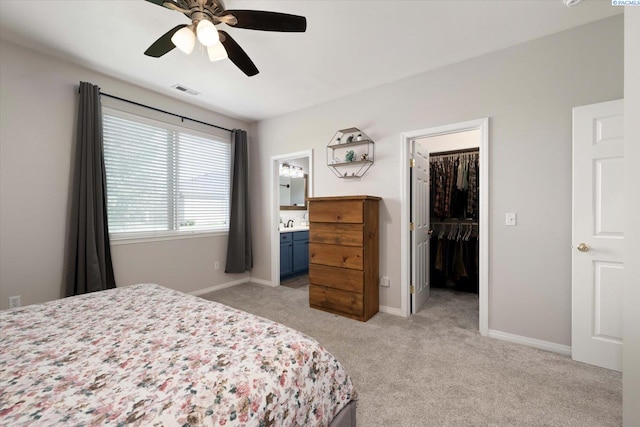 5 Hollyhock Ct, Pasco, WA 99301 - bedroom featuring a spacious closet, light carpet, ensuite bathroom, baseboards, and a closet