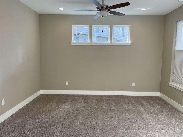empty room with recessed lighting, dark carpet, a ceiling fan, and baseboards