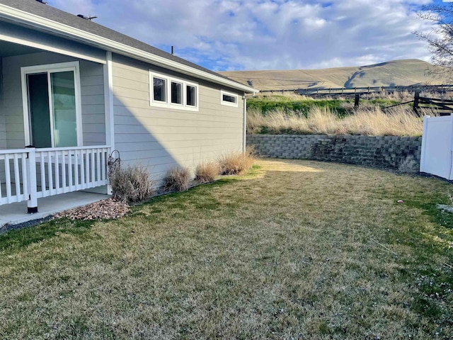 view of yard featuring a mountain view and fence