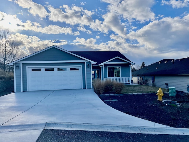 ranch-style home featuring central air condition unit, covered porch, driveway, and a garage