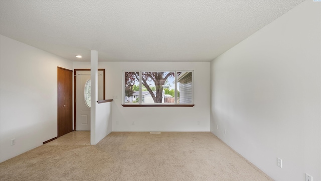 5456 Fern Loop, West Richland, WA 99352 - unfurnished room with light carpet, recessed lighting, and a textured ceiling