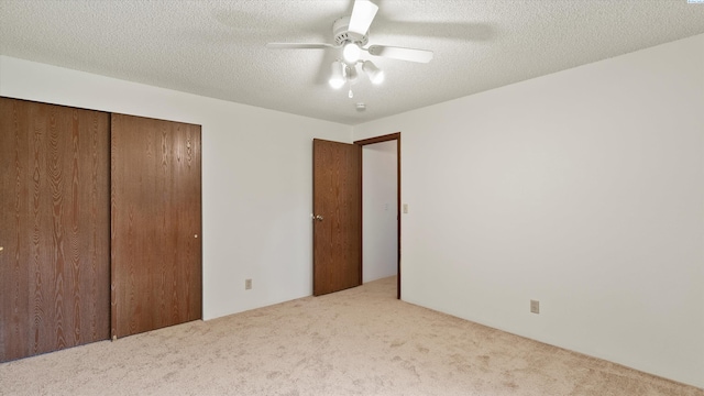 5456 Fern Loop, West Richland, WA 99352 - unfurnished bedroom featuring carpet flooring, a closet, a ceiling fan, and a textured ceiling