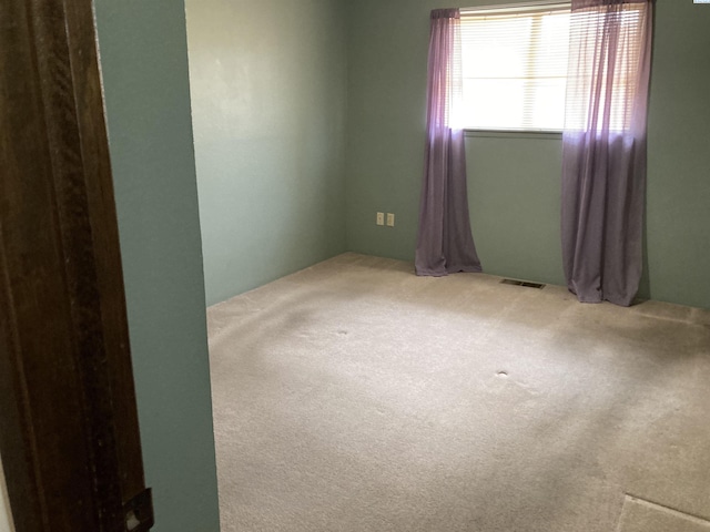 carpeted empty room with visible vents