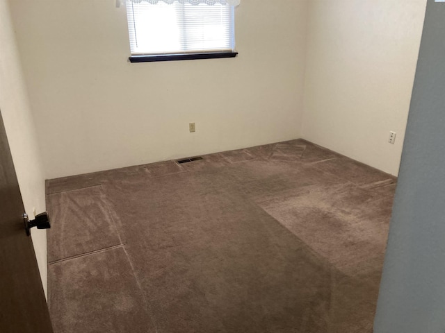 carpeted spare room with visible vents