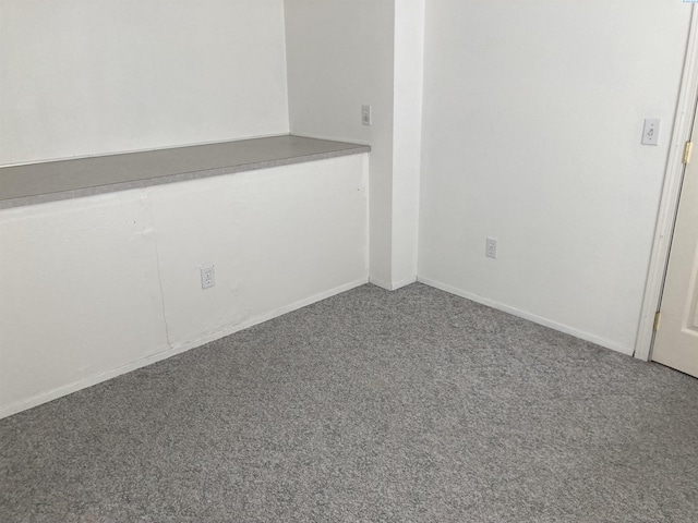 spare room featuring carpet flooring and baseboards