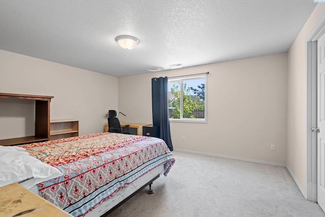 carpeted bedroom with a textured ceiling