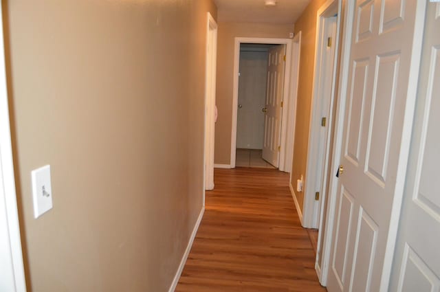 corridor with light hardwood / wood-style floors