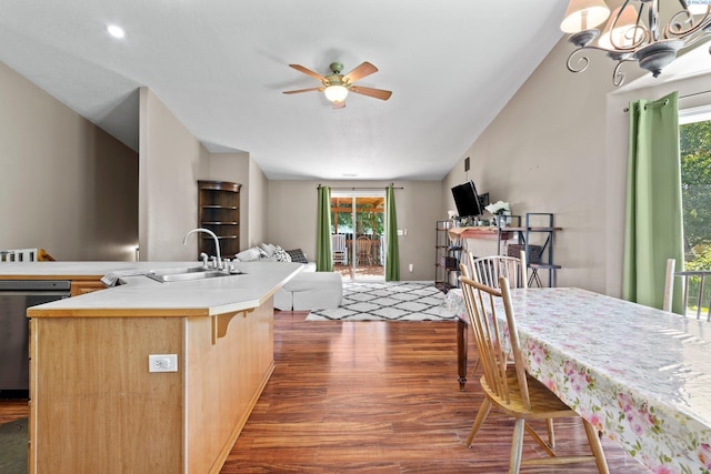 kitchen featuring sink, dark hardwood / wood-style flooring, dishwashing machine, an island with sink, and ceiling fan with notable chandelier