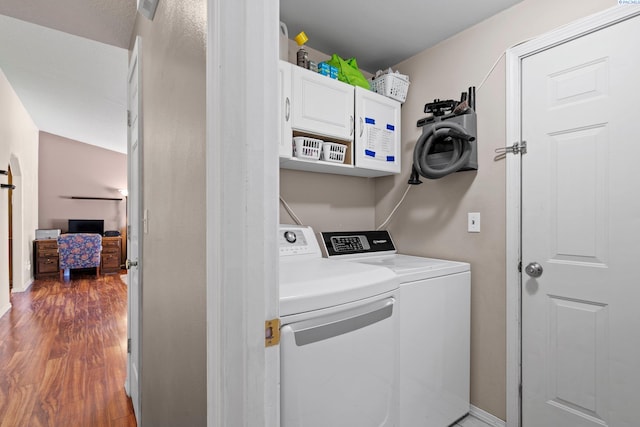 laundry area with cabinets, wood-type flooring, and independent washer and dryer