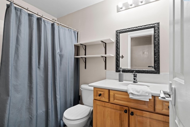 bathroom featuring vanity, a shower with curtain, and toilet