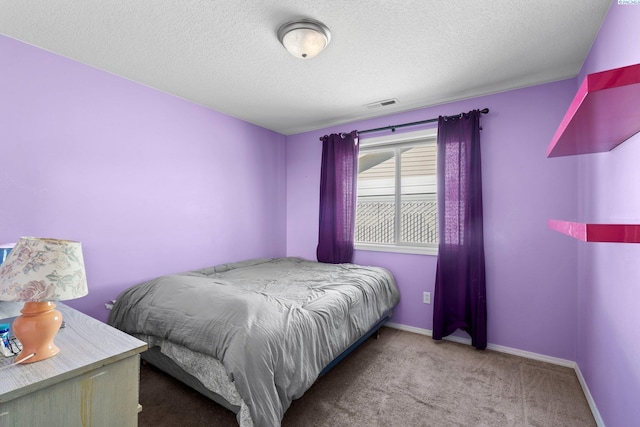 carpeted bedroom with a textured ceiling