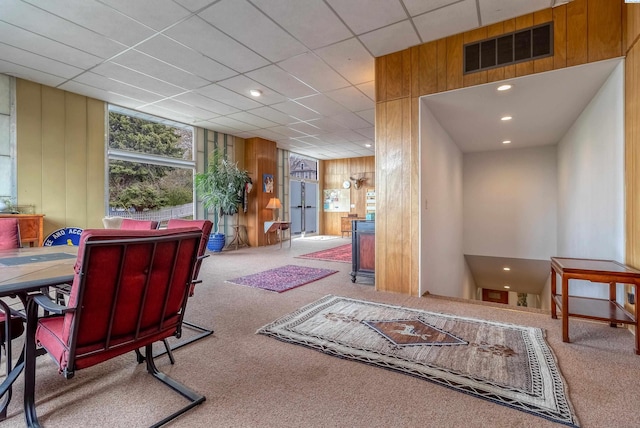 interior space with wooden walls, visible vents, and recessed lighting