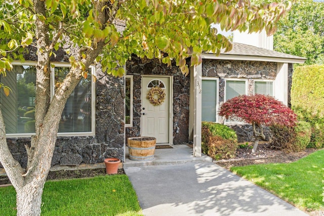 entrance to property featuring stone siding