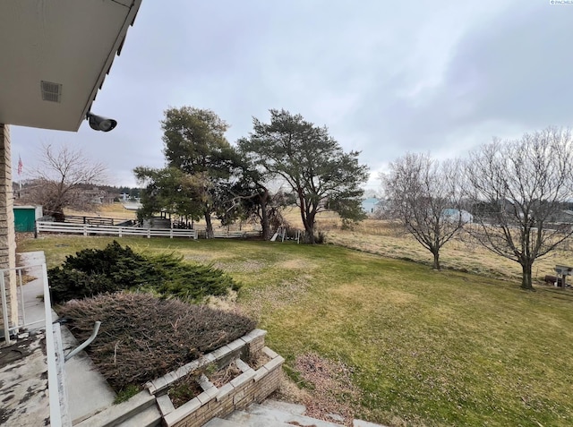 view of yard featuring a rural view and fence