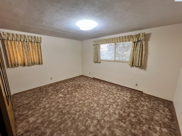 carpeted spare room featuring a textured ceiling, a baseboard radiator, and baseboards