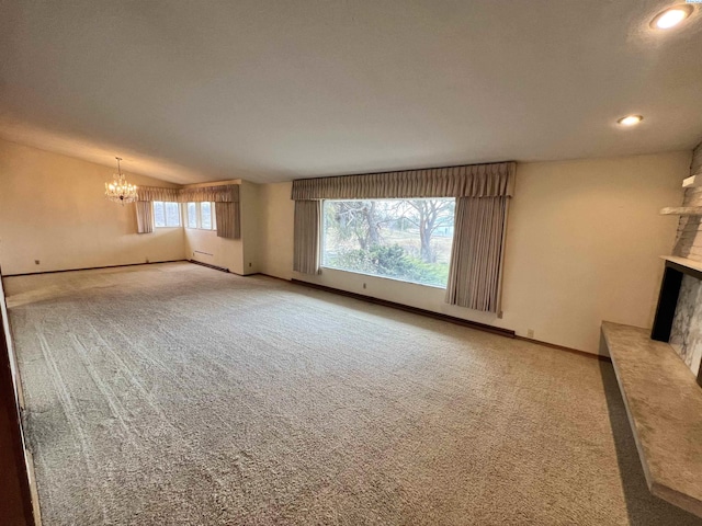 unfurnished living room with a chandelier, recessed lighting, light colored carpet, baseboards, and vaulted ceiling