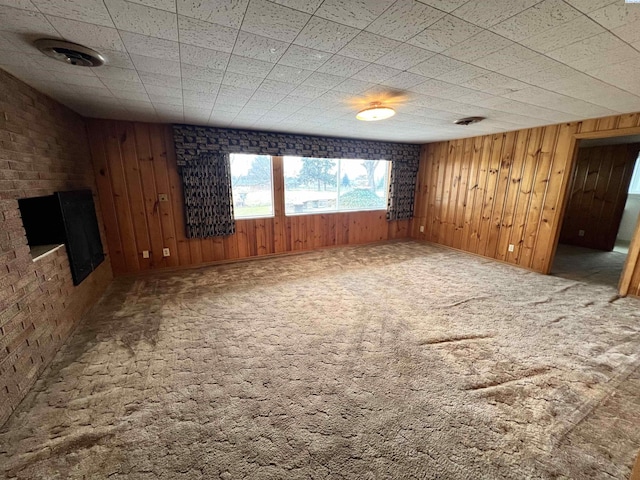 carpeted empty room with wooden walls